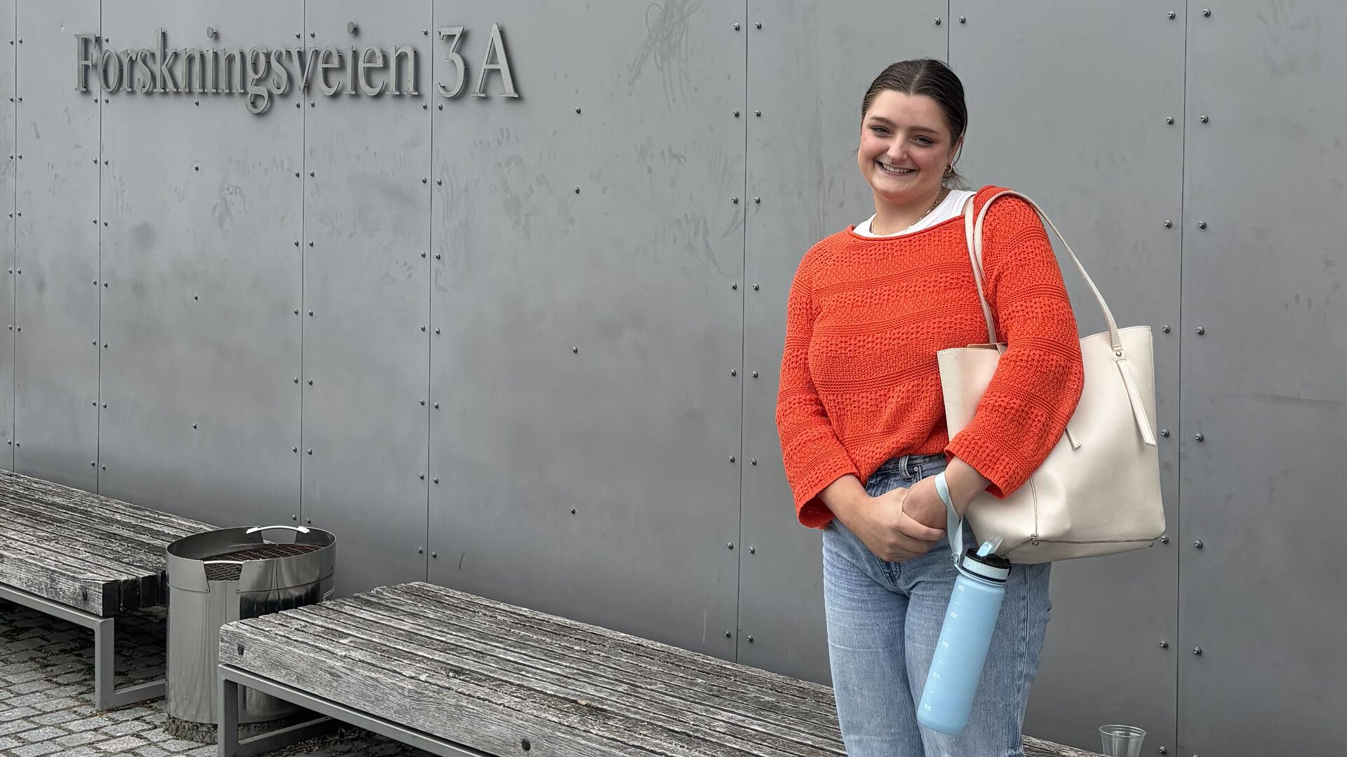 Woman in front of building.