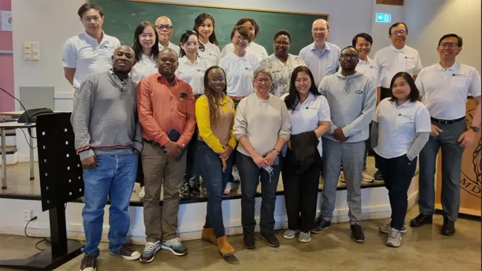 A group of researchers stadning together, smiling