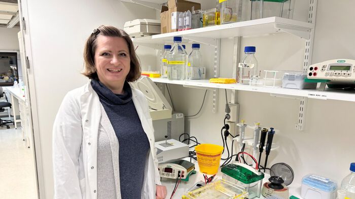 Image shows a woman in a lab