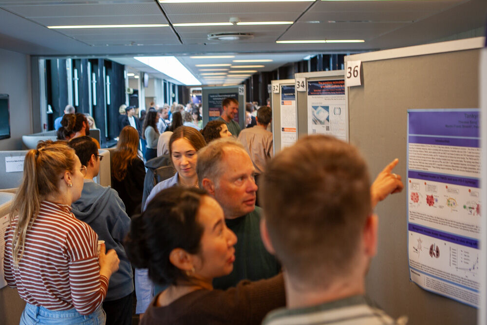 Researchers discussing a science poster