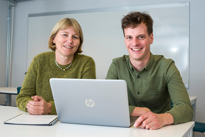 Two persons and a laptop. Professor Marit Veierød and PhD Candidate Simon Lergenmuller at the Institute of Basic Medical Sciences, University of Oslo.